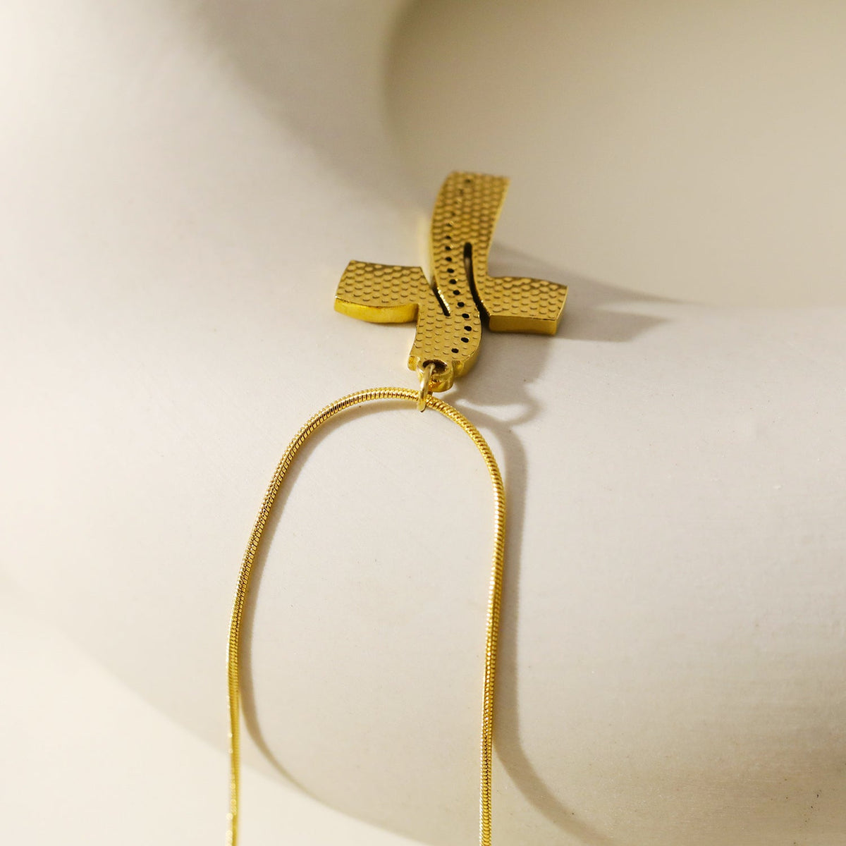 ARCASSA: Zirconia Embedded Hammered Finish Cross Pendant on a Mini Snake Skin Textured Chain Necklace.