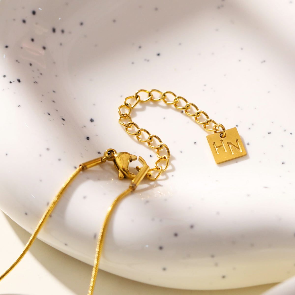 ARCASSA: Zirconia Embedded Hammered Finish Cross Pendant on a Mini Snake Skin Textured Chain Necklace.