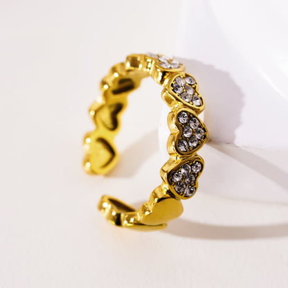 JEZREEL: Heart-Shaped Mini Charms Encircled Ring With Zirconia Crystal Centre Pieces