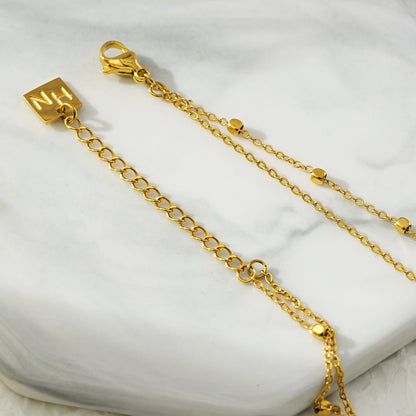 HILDA LG : Bracelet de cheville perles carrées et perles rondes deux-en-un noir et or.